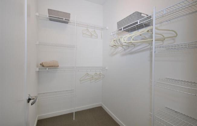 a walk in closet in a bedroom