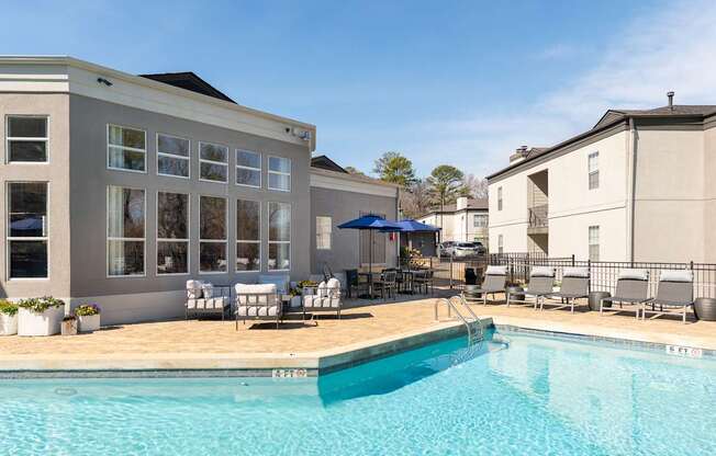 our apartments have a swimming pool with chairs and umbrellas