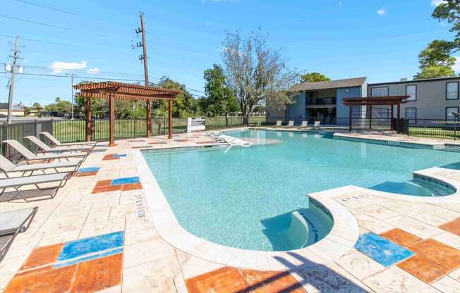 A pool with a brown pergola and a blue tile border.
