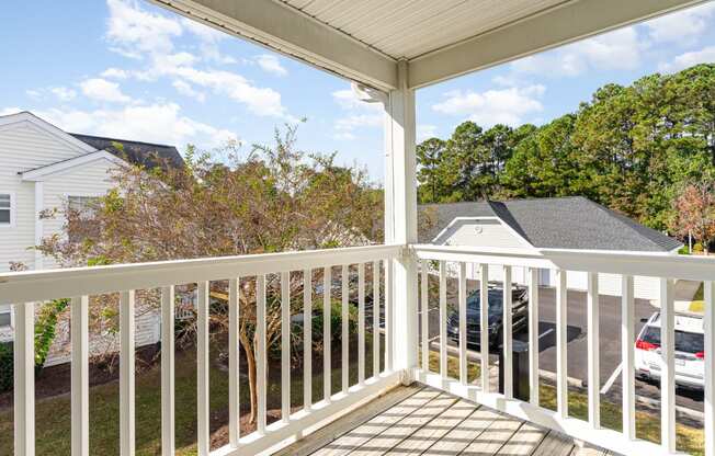 the view from the deck of a home with a white railing
