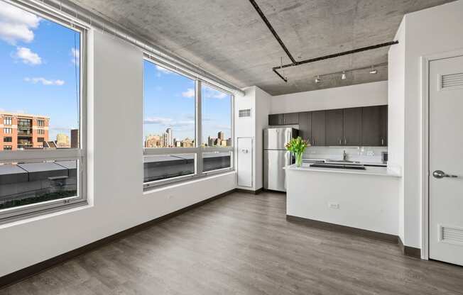 a kitchen with a large window and a view of a city at Lakeview 3200 Apartments, Chicago, IL, 60657