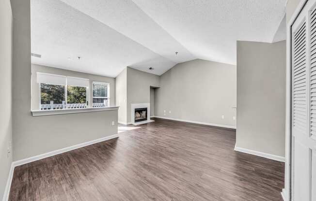 the living room and dining room of a new home with a fireplace