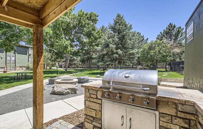 a patio with a barbecue grill and a picnic table