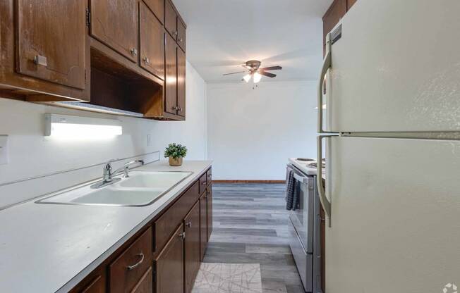 a kitchen with a sink and a refrigerator