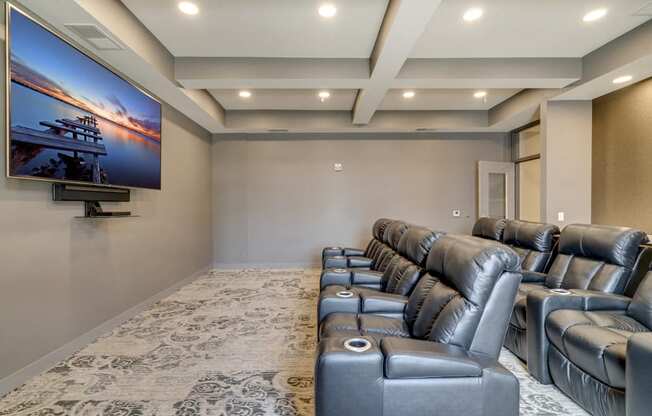 Theater room with leather seating and large TV at Ascend at Woodbury MN