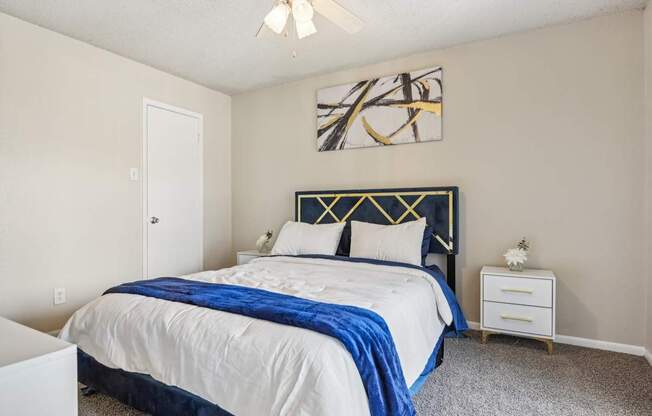 a bedroom with a bed and a ceiling fan at The Glen at Highpoint, Dallas, 75243