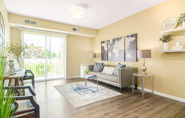 a living room with yellow walls and a sliding glass door