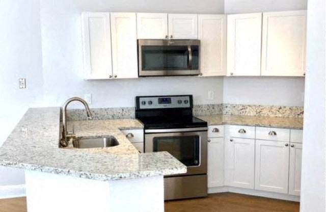 a kitchen with a stove a sink and a microwave