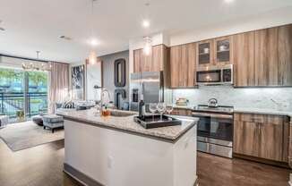 A modern kitchen with wooden cabinets and stainless steel appliances.