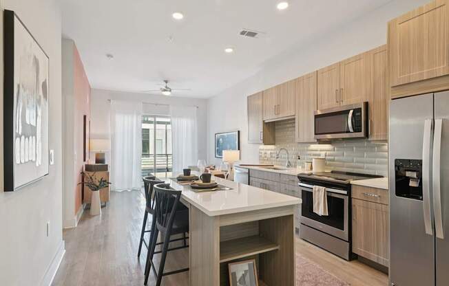 A modern kitchen with a dining table and chairs.
