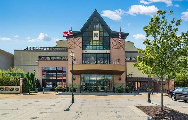 a large building with two flags in front of it
