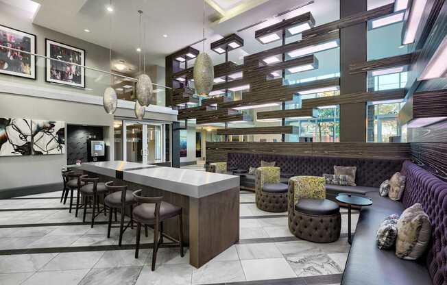 A modern bar area with a long counter and stools.