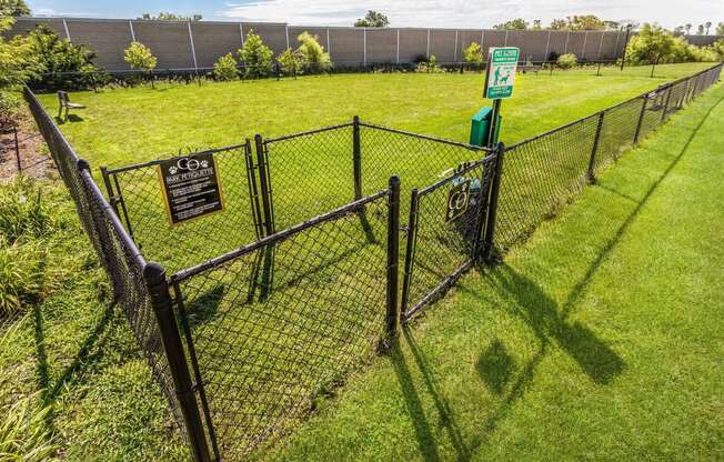 a chain link fence with a sign on it in a field