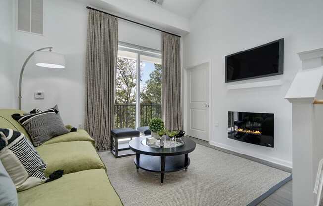 a living room with a couch and a coffee table and a fireplace