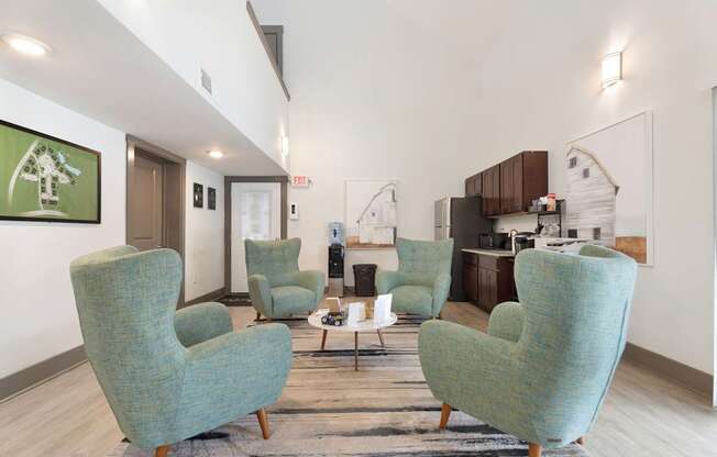 A living room with a green chair and a white wall.