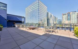 a terrace with tables and chairs on top of a building