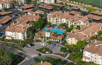A large apartment complex with a pool in the middle.
