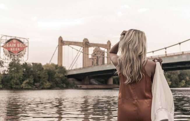 woman outlooking bridge over river