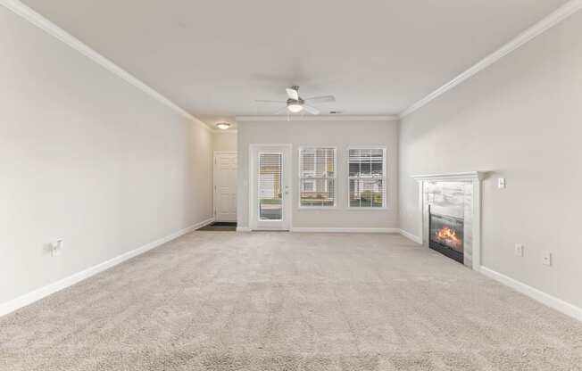 Living Room with Fire Place and windows looking out on Patio