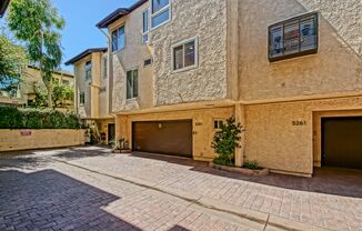 BRIGHT & AIRY, REAR-UNIT TOWNHOUSE W/ SPACIOUS PATIO, BALCONY & HUGE 2-CAR GARAGE IN GATED COMMUNITY W/ POOL & CLUBHOUSE!