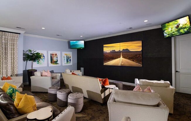 A living room with a large screen TV and a couch.