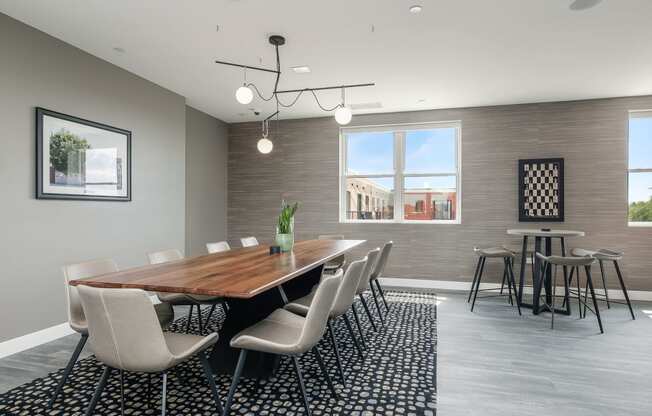 a dining room with a wooden table and chairs