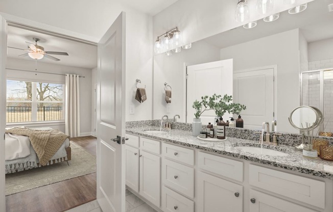a bathroom with white cabinets and a sink and a mirror