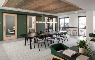 A conference room with a long table and chairs.