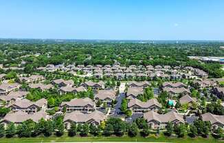 A bird's eye view of a residential neighborhood with houses and trees.