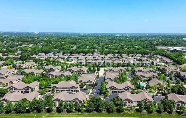 A bird's eye view of a residential neighborhood with houses and trees.