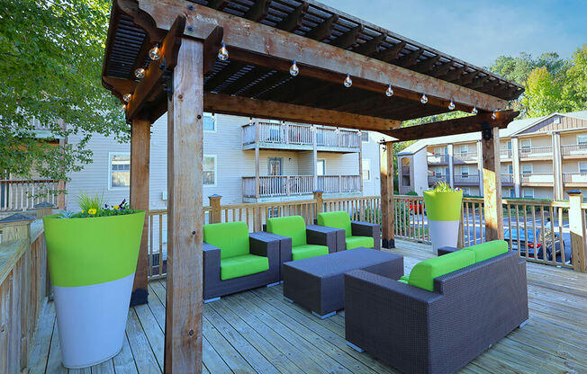 a deck with a pergola and patio furniture