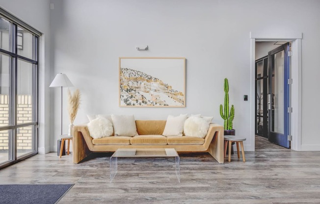 a living room with a couch and a cactus in front of a window at Copper 87, West Jordan Utah