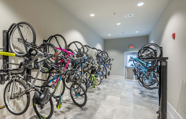 a row of bikes parked on a rack in a building