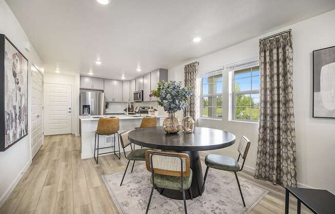 a kitchen and dining room with a table and chairs