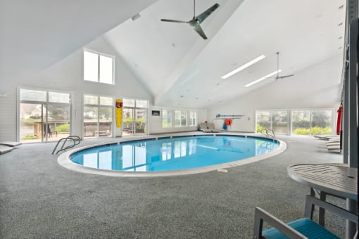 a large indoor swimming pool with a ceiling fan at Linkhorn Bay Apartments, Virginia Beach, Virginia