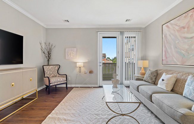 Cozy living room at Kelly’s Ridge Apartments featuring elegant finishes and private patio access.