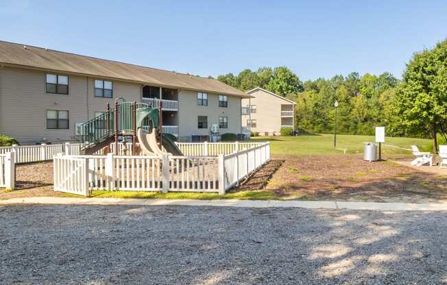 a white fence in front of an apartment building