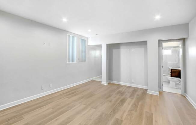 a renovated living room with white walls and wood floors