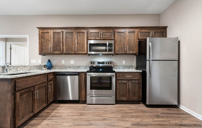 a kitchen with stainless steel appliances and wooden cabinets