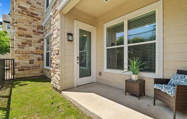 A house with a patio and a chair.