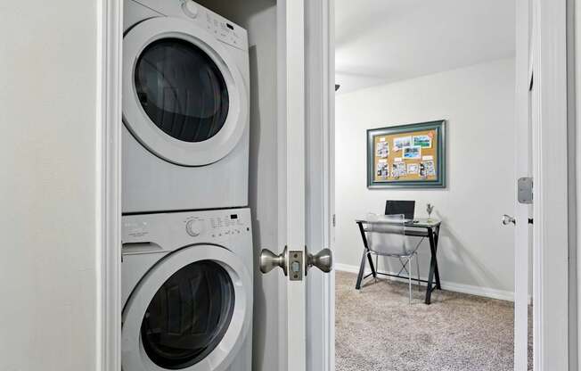 A white washing machine is in a doorway.