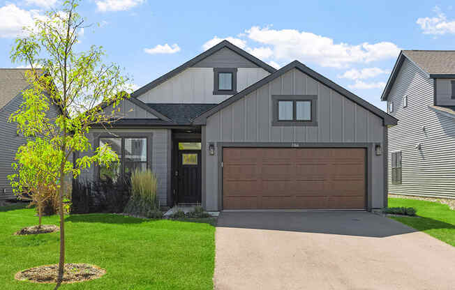 a house with a brown garage door and a driveway