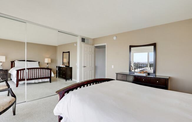 Bedroom with mirrored closet doors, carpet floorings