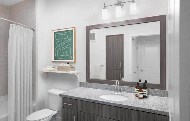 A bathroom with a white sink and a mirror above it.