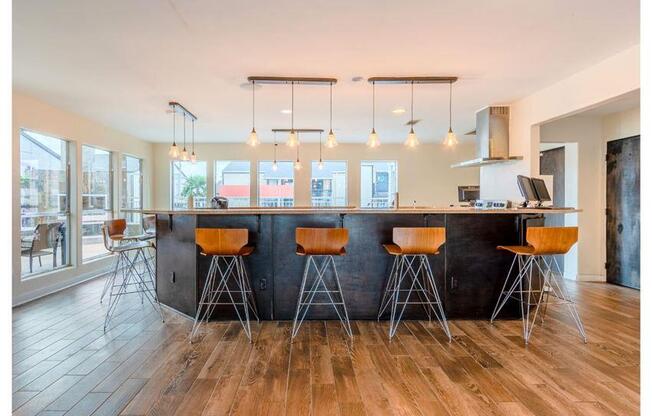 a kitchen with a counter and bar stools