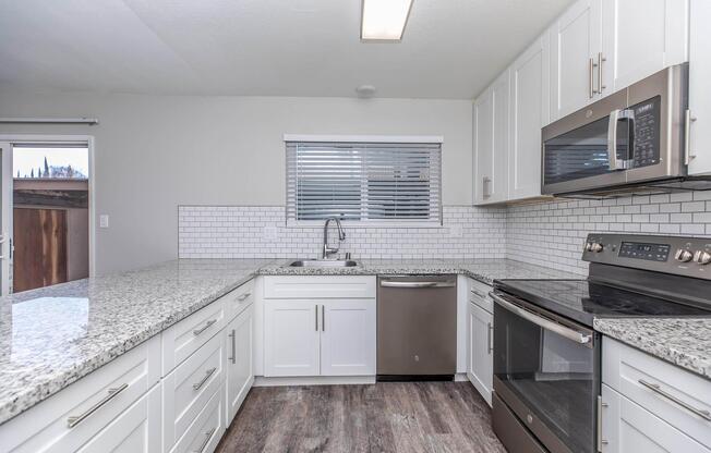 a large kitchen with stainless steel appliances