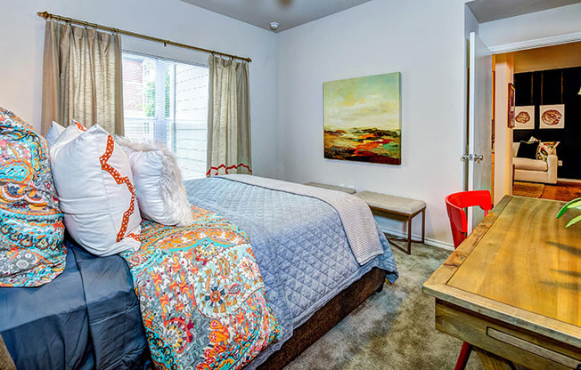 a bedroom with a bed and a desk at Villa Espada Apartments, San Antonio