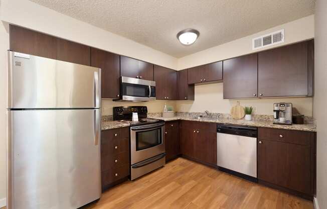 a kitchen with stainless steel appliances and wooden cabinets