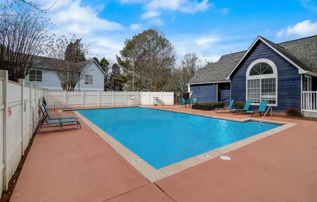 a swimming pool with a house and a fence around it at The Sapphire, Decatur, GA, 30035