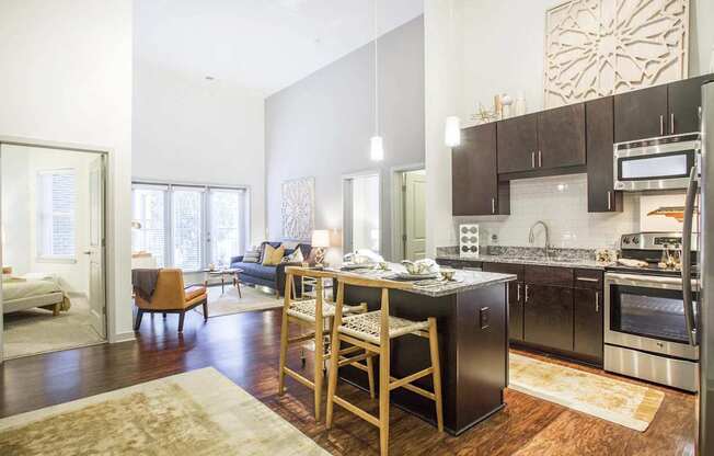 A kitchen with a table and chairs in the middle of the room.